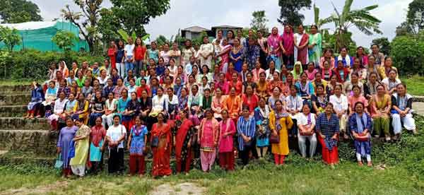 A large group of farmers gathered together outdoors