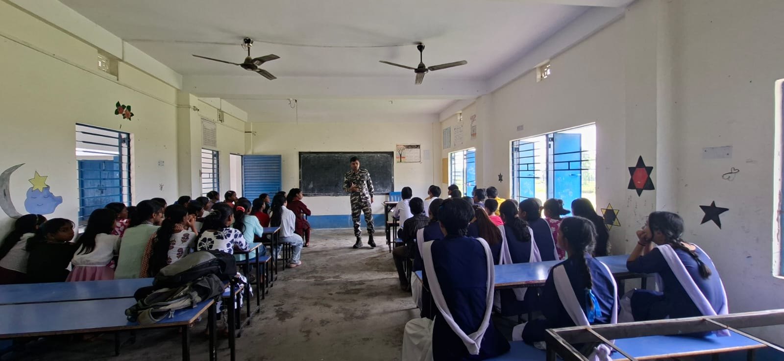 A speaker addressing a room of students during a community awareness session